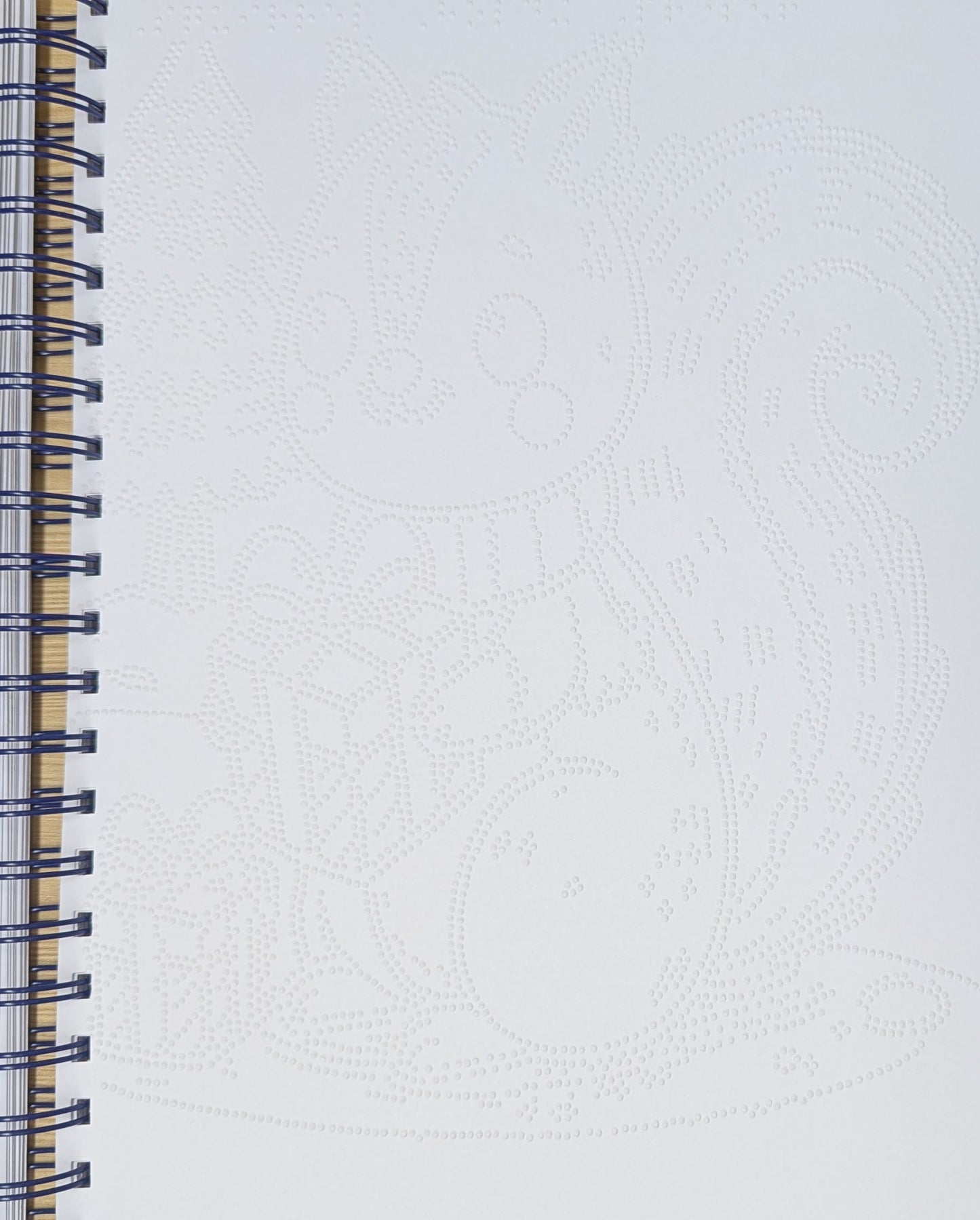 a close up braille image page showing a braille Christmas cat design.