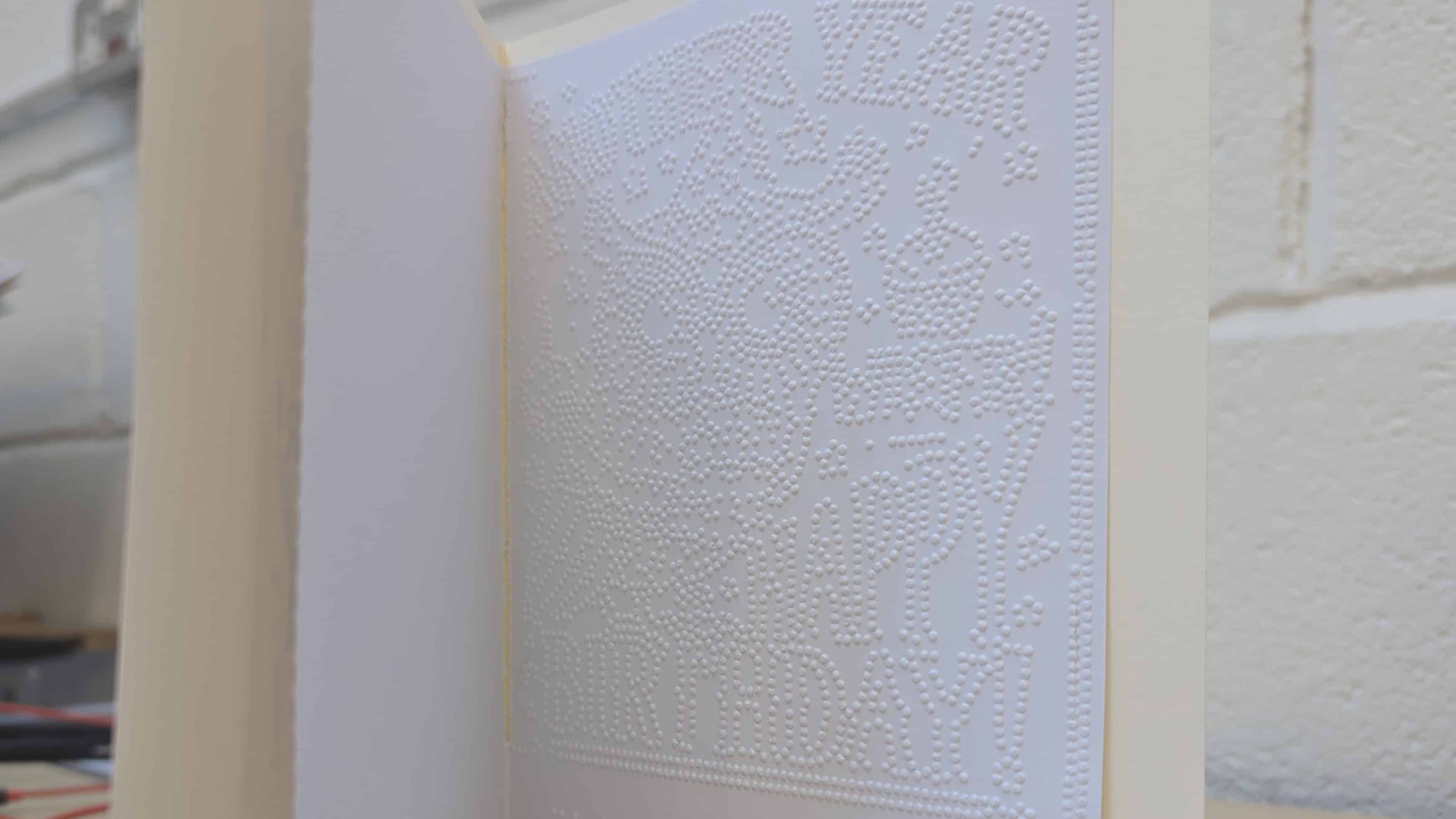 A close up photo of the braille inside our braille cards