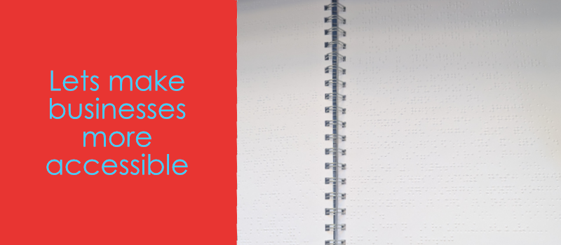 Banner with one side saying "Lets make businesses more accessible" with a red background. on the other side is an image of a braille transcribed notebook.
